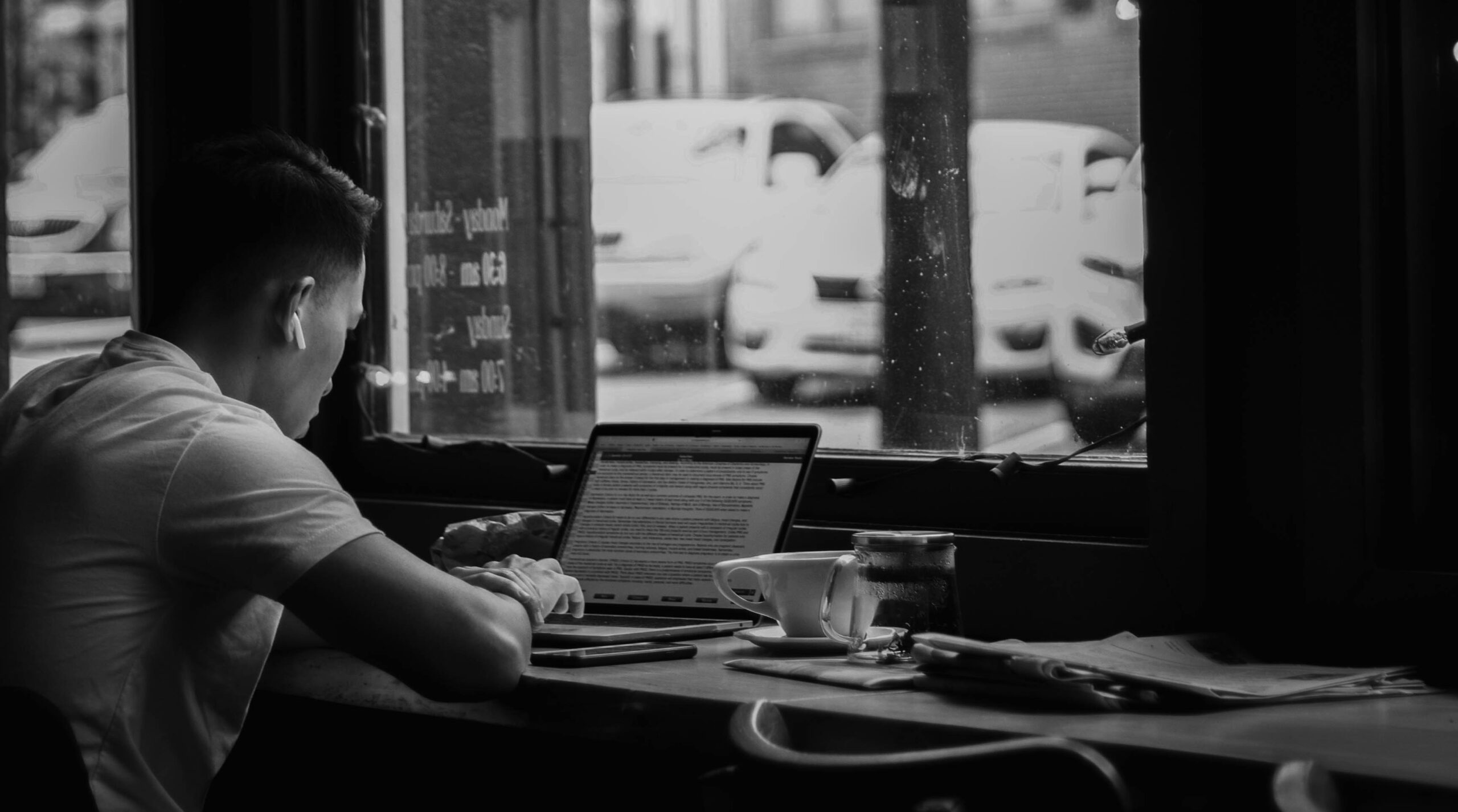 Marketer using a laptop to implement lead nurturing automation tools.