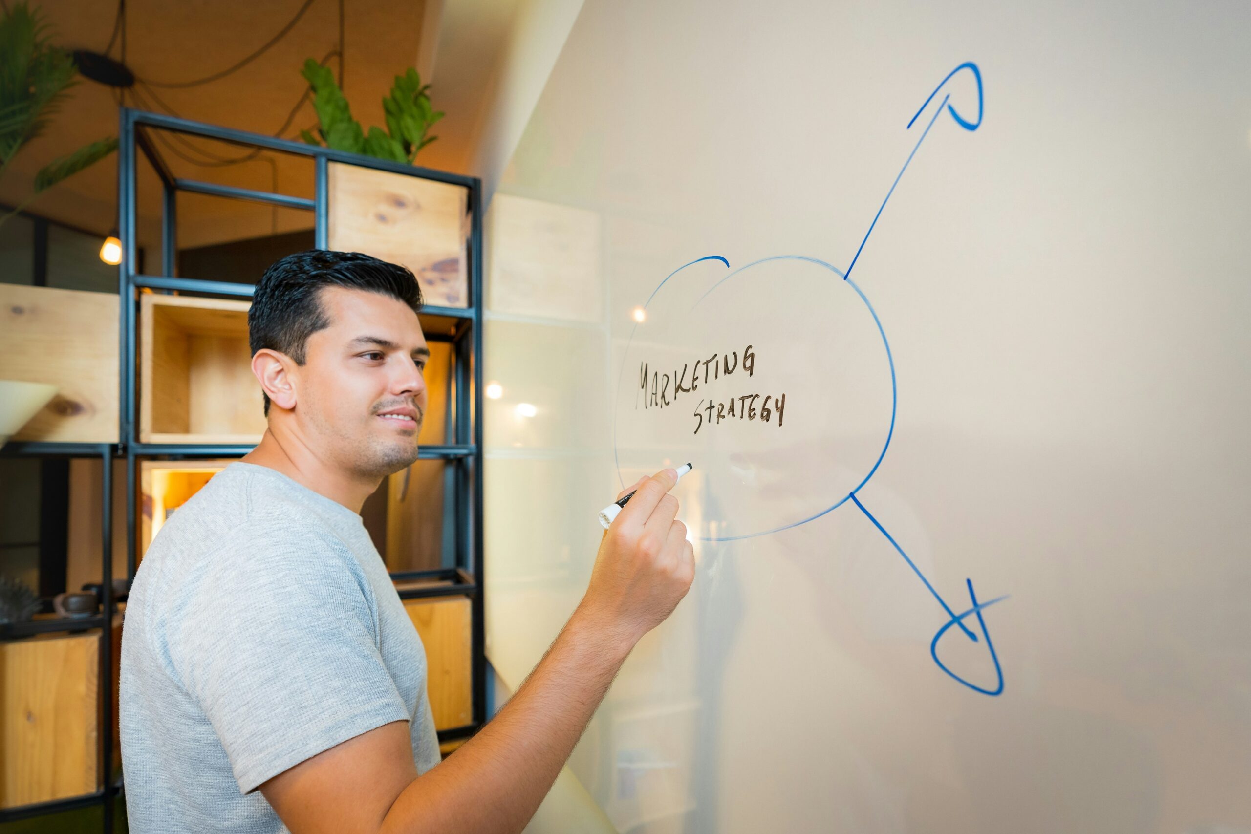 a person writing on a white board - Nurture Machines a person writing on a white board
