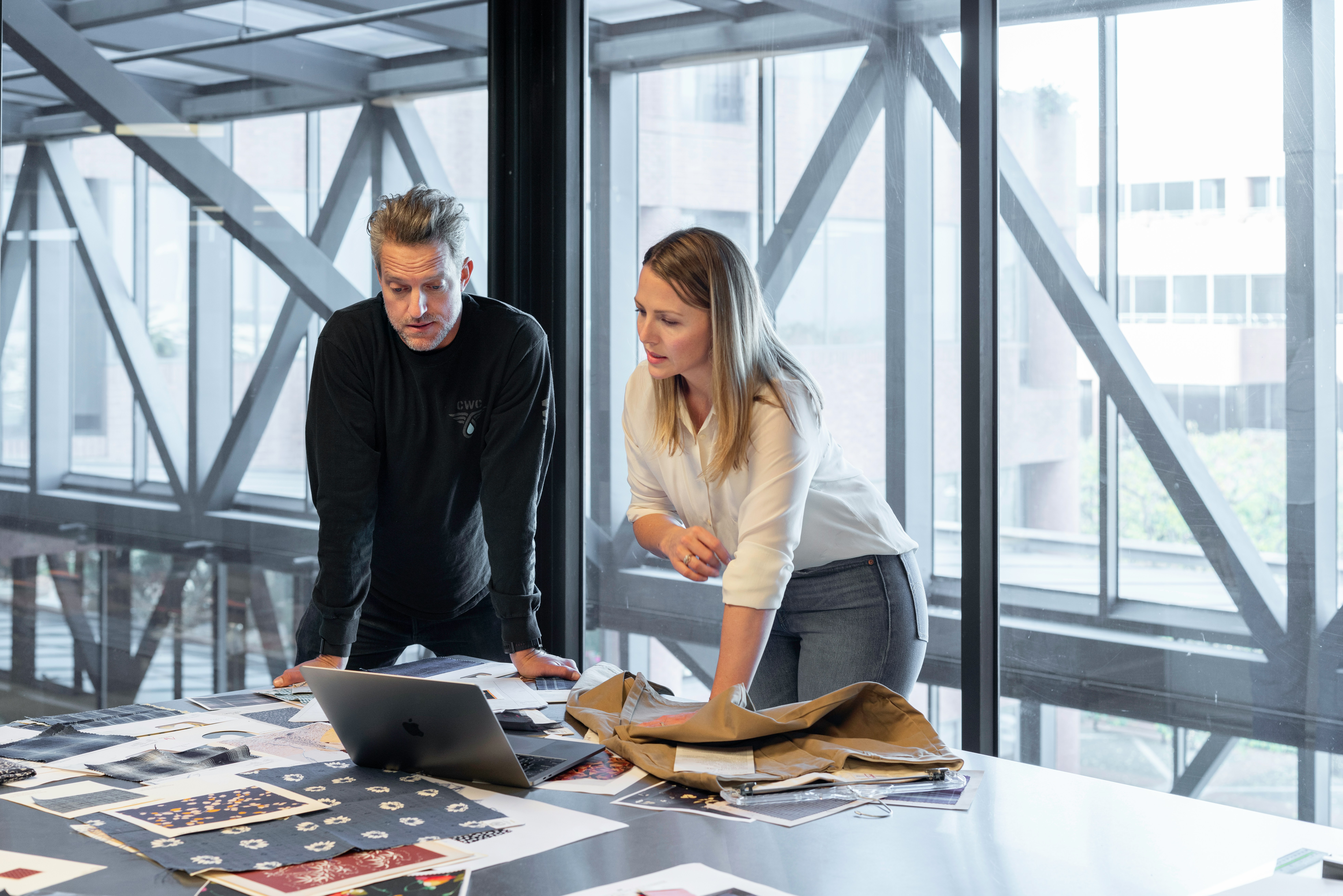 Colleagues reviewing customer journey visuals in a modern office setting. - Nurture Machines Colleagues reviewing customer journey visuals in a modern office setting.
