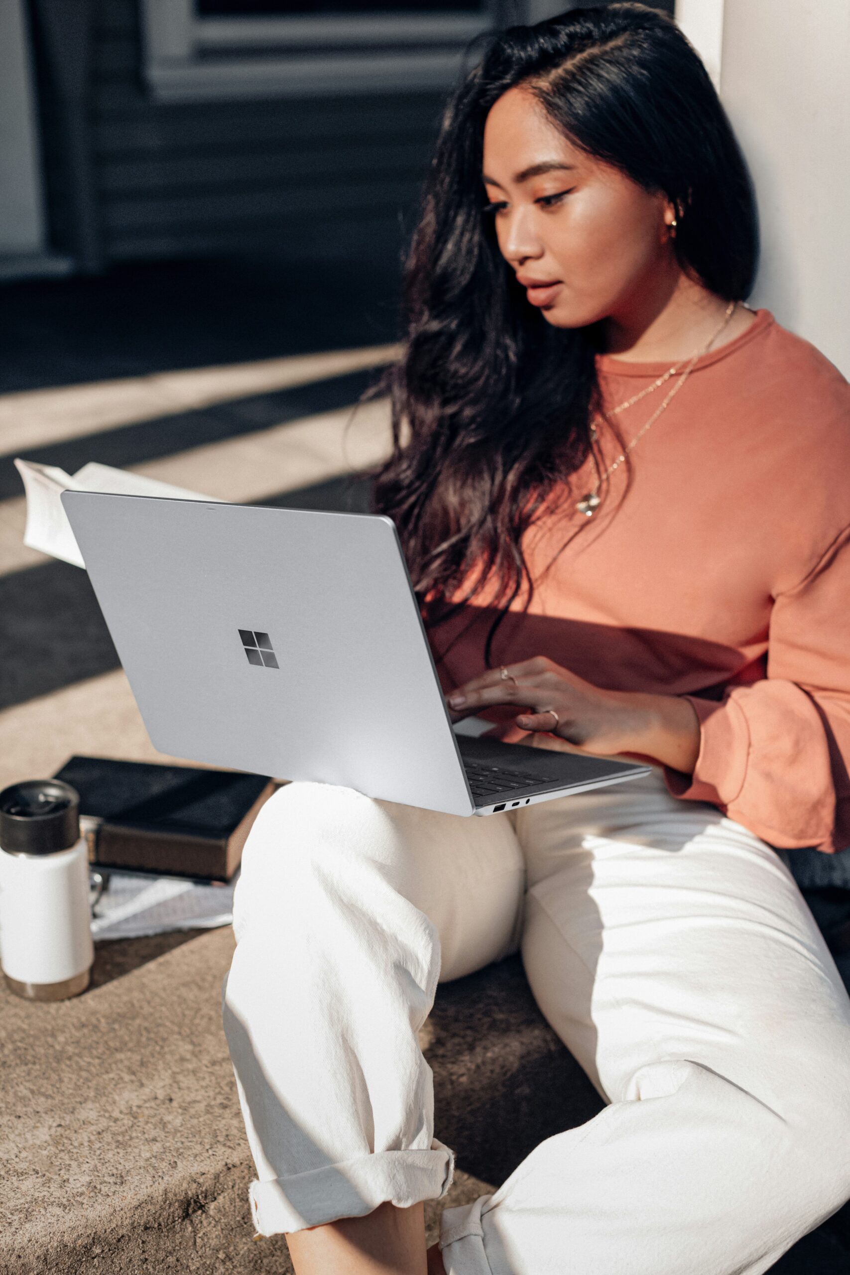 a woman working on her laptop - Nurture Machines a woman working on her laptop