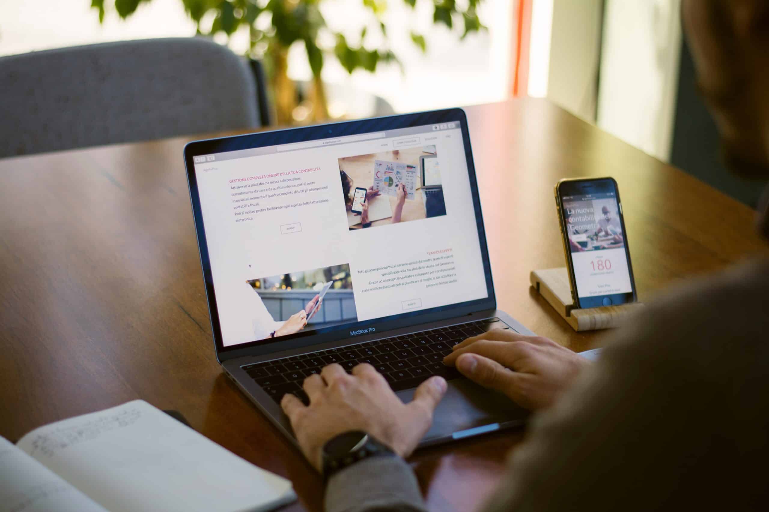 Person engaging with branded content on laptop and smartphone