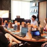 A business team attentively listens during a presentation, highlighting how exceptional customer service fosters engagement, satisfaction, and long-term retention.