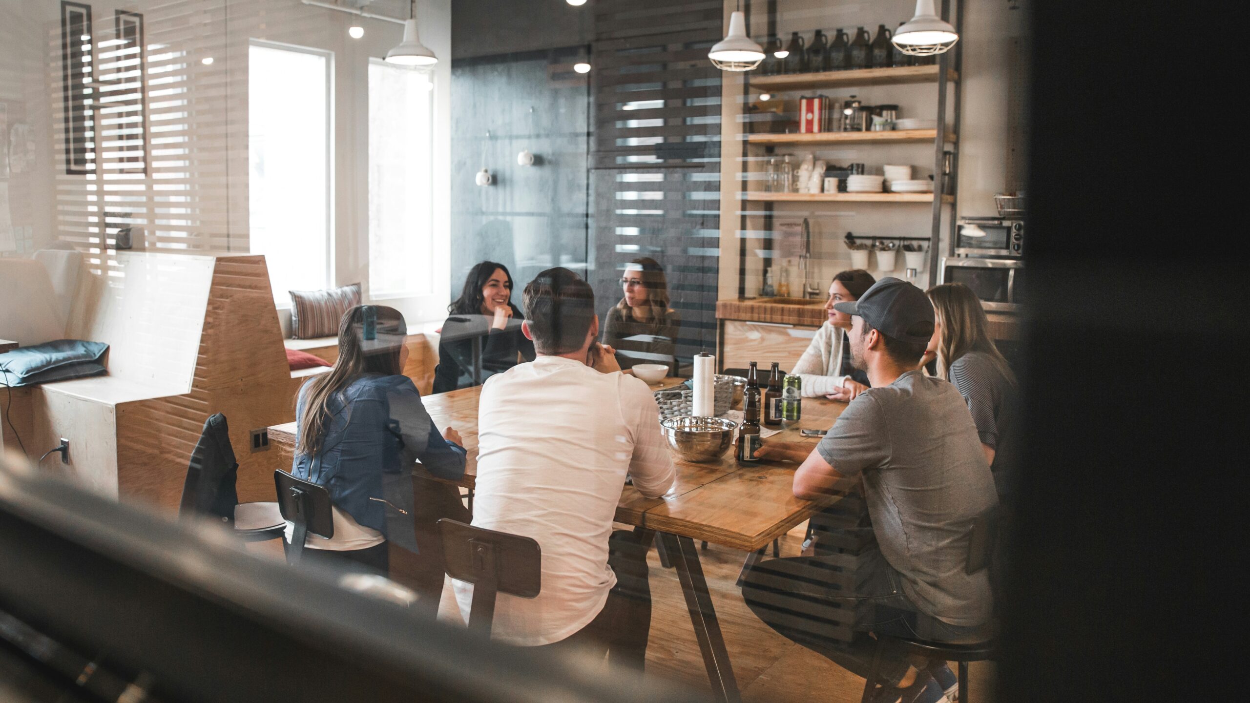 A team gathers in a modern workspace, brainstorming how to strategically plan and execute promotions that effectively lower customer acquisition costs.