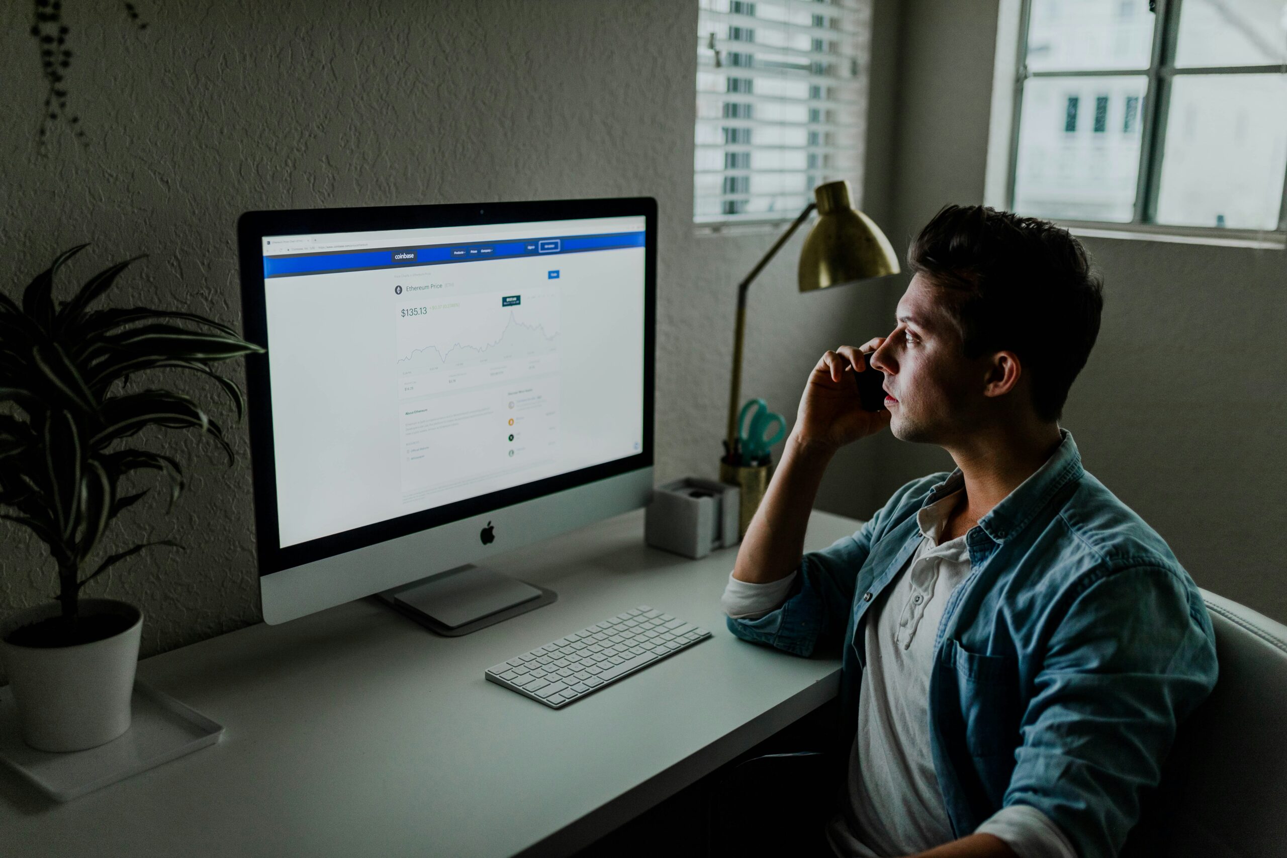 A person analyzing campaign performance on a desktop screen while on a call, symbolizing efforts to measure and improve marketing ROI for acquisition strategies. - Nurture Machines A person analyzing campaign performance on a desktop screen while on a call, symbolizing efforts to measure and improve marketing ROI for acquisition strategies.