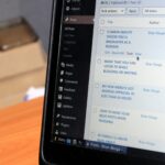 A laptop screen displaying blog post drafts, ideal for organizing content into topic clusters and adding internal links for funnel optimization.