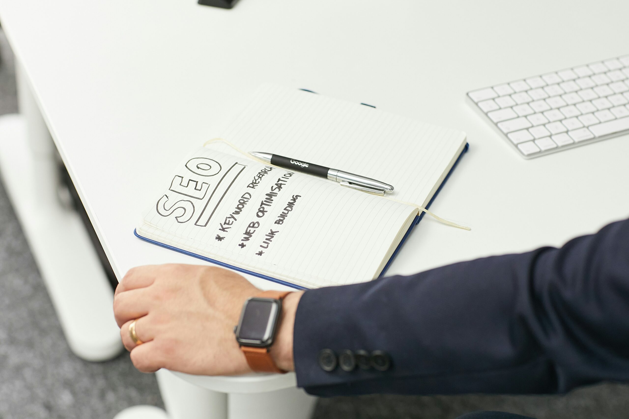A notebook with SEO strategies sits on a desk, highlighting content marketing tactics that fuel lead generation. - Nurture Machines A notebook with SEO strategies sits on a desk, highlighting content marketing tactics that fuel lead generation.