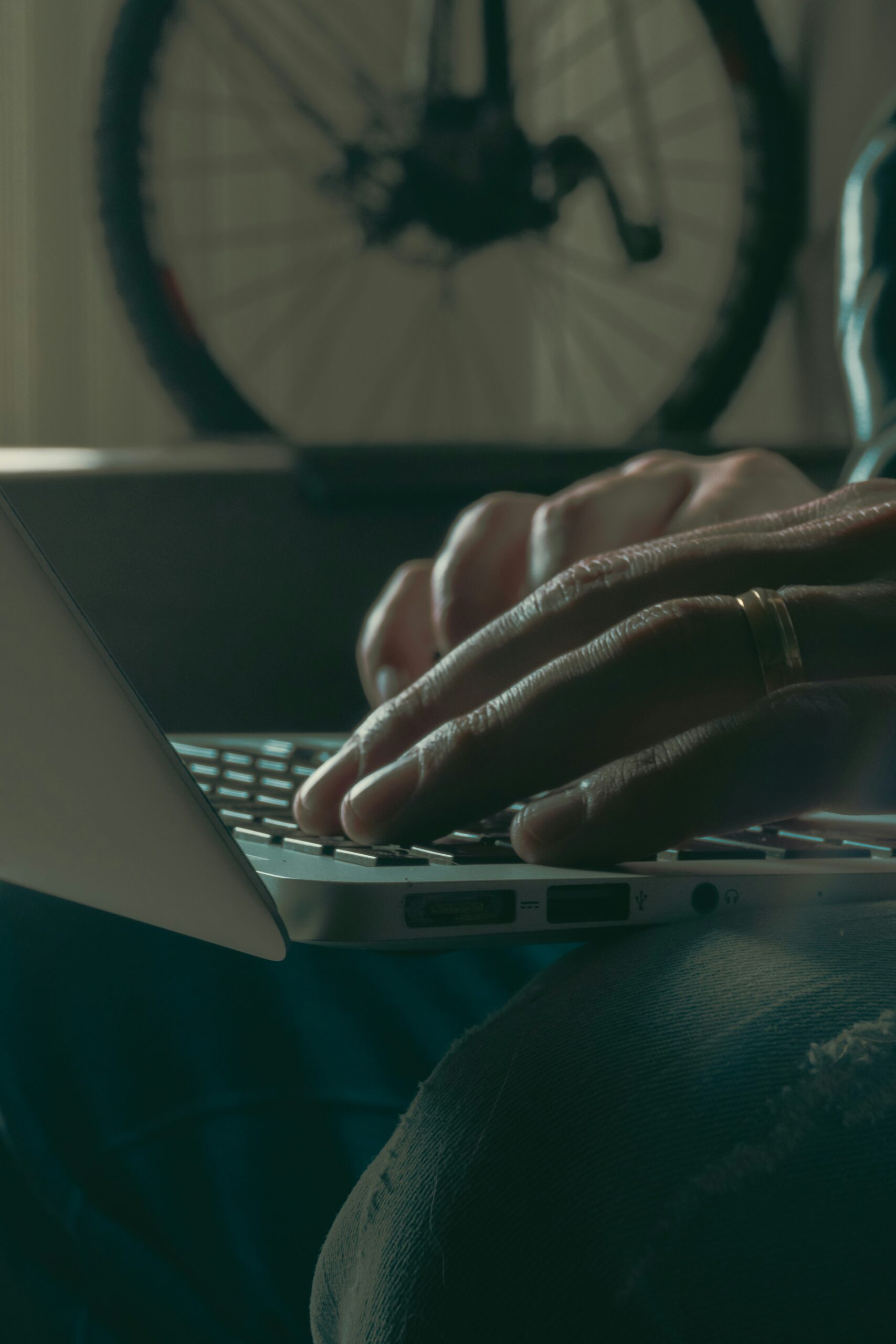 Close-up of hands typing on a laptop, symbolizing the digital collection and strategic use of customer feedback for business improvement.