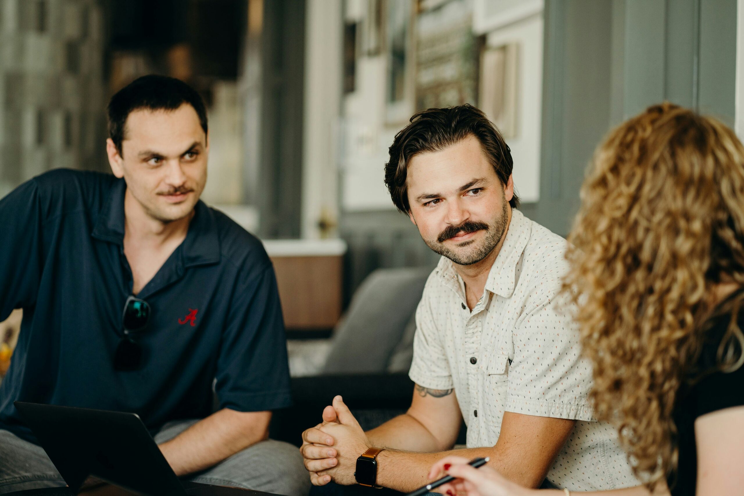 A group of professionals in discussion, reflecting the strategic planning and problem-solving required to overcome challenges in implementing referral programs. - Nurture Machines A group of professionals in discussion, reflecting the strategic planning and problem-solving required to overcome challenges in implementing referral programs.